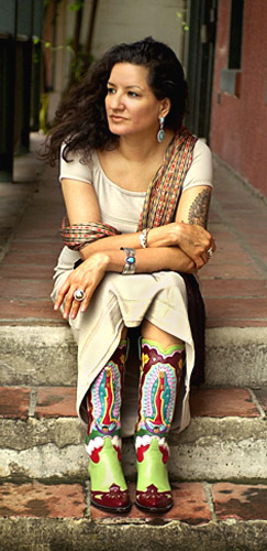 Author Sandra Cisneros sits for a portrait in San Antonio, Sept. 16, 2002. "You can't get famous in Texas," she writes in her new novel, "Caramelo," but the 48-year-old Cisneros defies that theme as her fame grows from coast to coast. (AP Photo/Eric Gay)